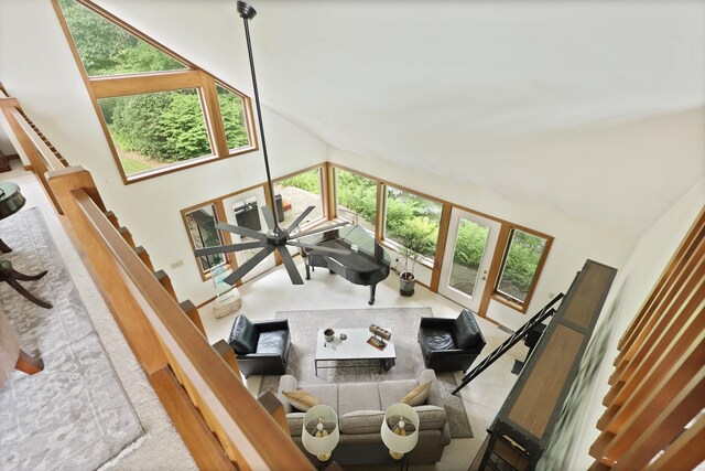 9300 Ormes Rd, Vassar, MI 49768 - living room featuring high vaulted ceiling and stairs