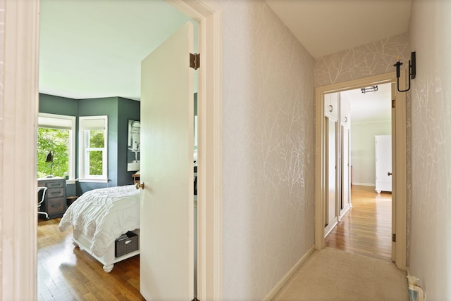 hallway with light hardwood / wood-style floors