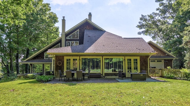 back of property featuring a lawn, a patio, and french doors