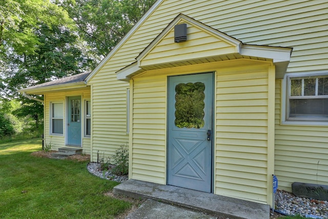 entrance to property with a lawn