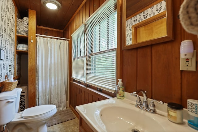 bathroom with toilet, wooden ceiling, tile patterned floors, and wooden walls