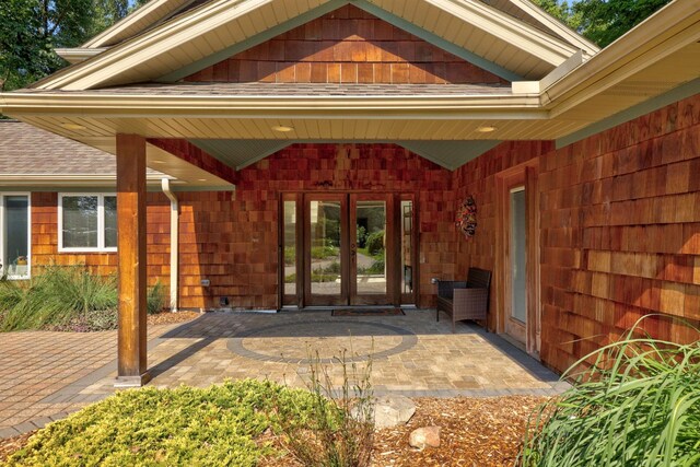 9300 Ormes Rd, Vassar, MI 49768 - doorway to property featuring french doors, a patio area, and roof with shingles