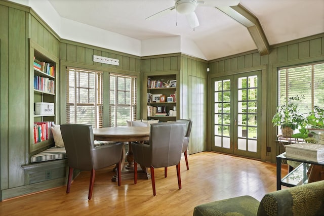 dining area with french doors, light wood-type flooring, built in shelves, ceiling fan, and lofted ceiling