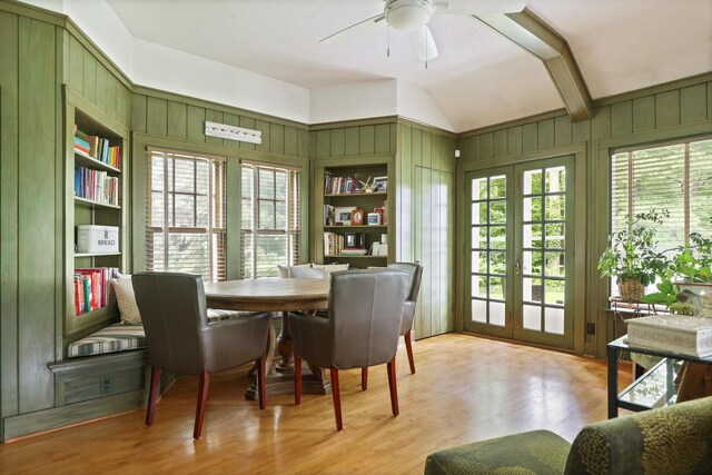 9300 Ormes Rd, Vassar, MI 49768 - dining room featuring lofted ceiling, wooden walls, french doors, light wood-style flooring, and ceiling fan