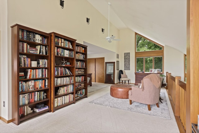 sitting room featuring light carpet, high vaulted ceiling, and ceiling fan