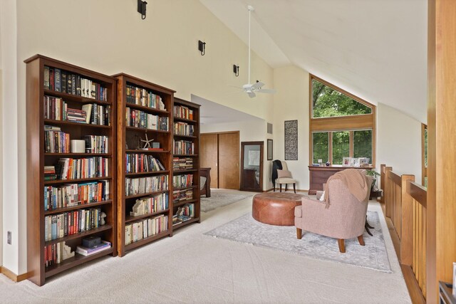 9300 Ormes Rd, Vassar, MI 49768 - living area with carpet, high vaulted ceiling, a ceiling fan, and bookshelves