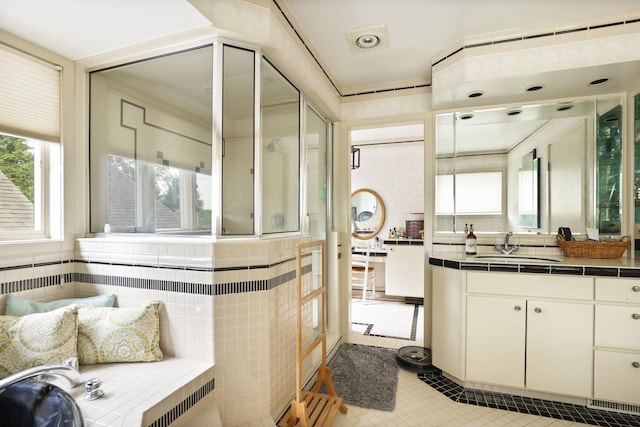 bathroom with vanity, tile patterned floors, and radiator