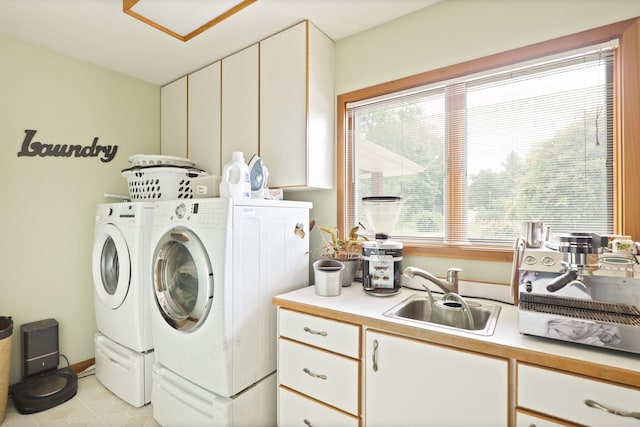 laundry area featuring sink, cabinets, and independent washer and dryer