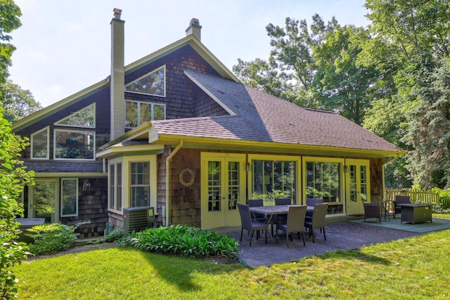 back of house with a lawn, a patio, and central AC