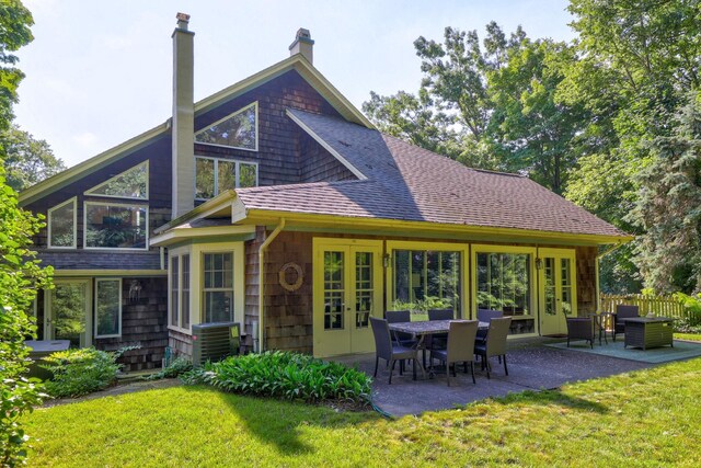 9300 Ormes Rd, Vassar, MI 49768 - rear view of property with french doors, a patio area, a chimney, roof with shingles, and cooling unit