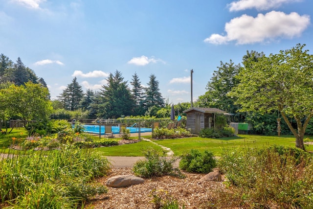 view of yard with a storage unit and tennis court