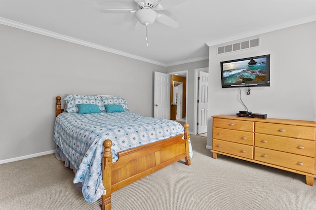 carpeted bedroom featuring ceiling fan and crown molding