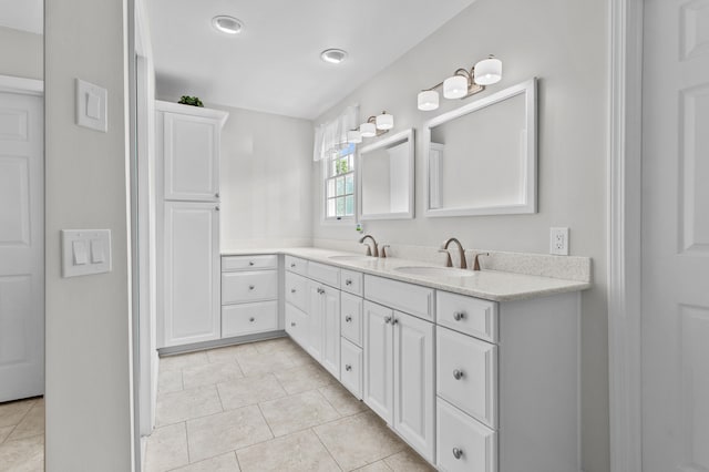 bathroom featuring tile patterned flooring and vanity