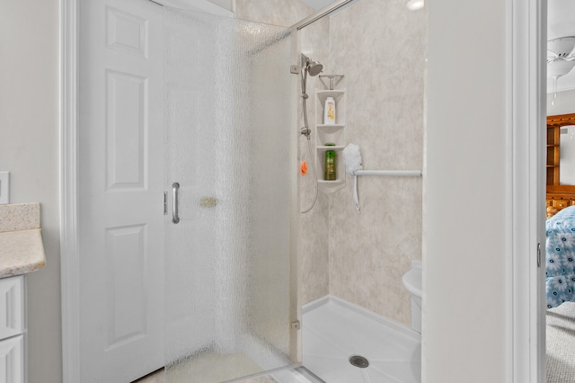 bathroom with vanity and a shower with door