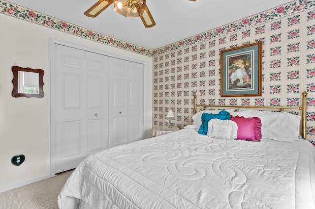 carpeted bedroom featuring a closet and ceiling fan