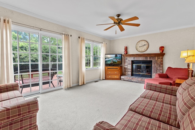 living room featuring crown molding, a wealth of natural light, and a brick fireplace