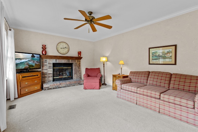 carpeted living room featuring crown molding, ceiling fan, and a brick fireplace