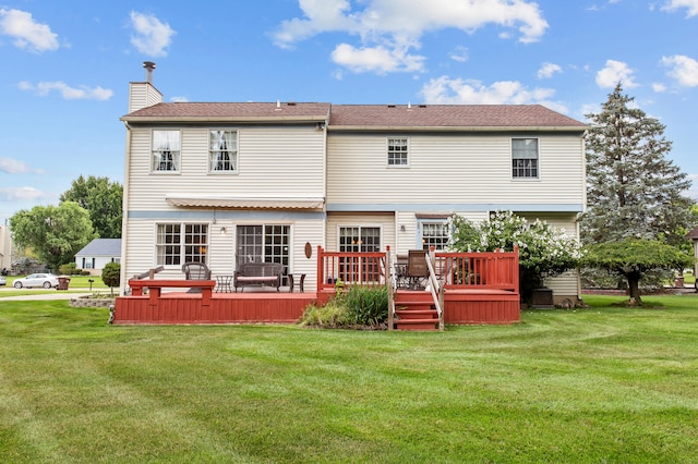 back of house featuring a deck and a lawn