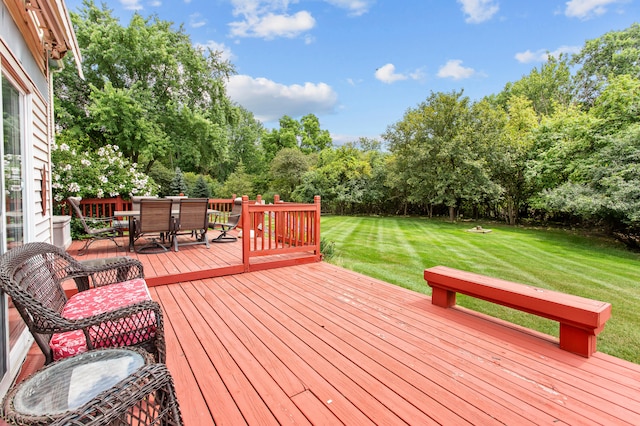 wooden deck featuring a yard