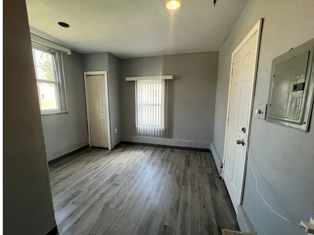 interior space with electric panel and hardwood / wood-style floors