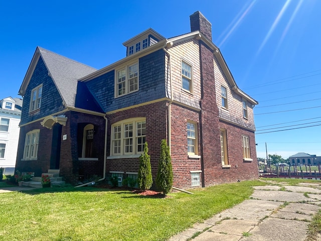 488 Parkview Dr, Detroit, MI 48214 - view of home's exterior with a lawn, a chimney, and brick siding