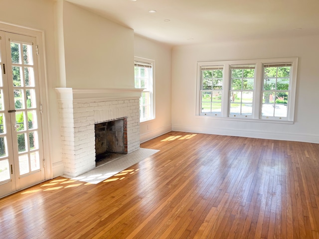 488 Parkview Dr, Detroit, MI 48214 - unfurnished living room featuring hardwood / wood-style floors, baseboards, and a brick fireplace