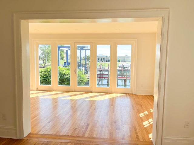 entryway with light hardwood / wood-style floors and french doors