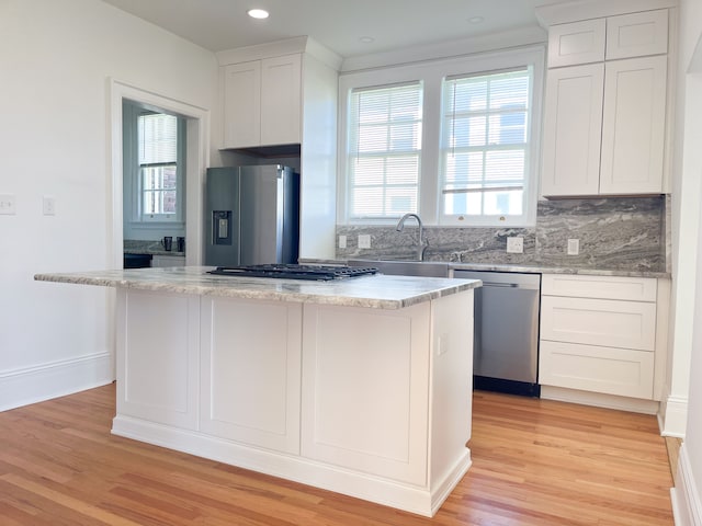 488 Parkview Dr, Detroit, MI 48214 - kitchen featuring appliances with stainless steel finishes, a kitchen island, healthy amount of natural light, light wood-style floors, and recessed lighting