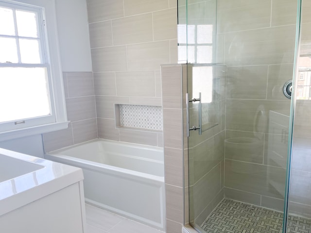 bathroom featuring tile patterned flooring and independent shower and bath