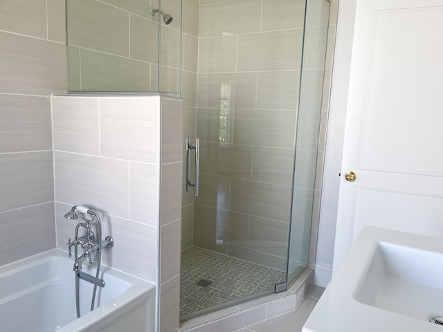 bathroom featuring separate shower and tub and sink