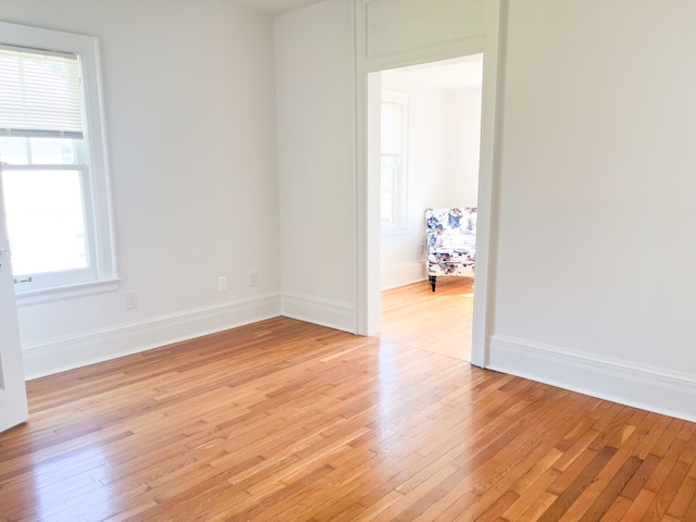 unfurnished room featuring a healthy amount of sunlight and light wood-type flooring