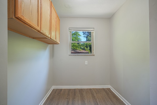 unfurnished room featuring a textured ceiling and dark hardwood / wood-style flooring