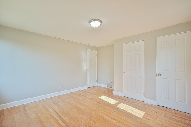 unfurnished bedroom featuring light wood-type flooring