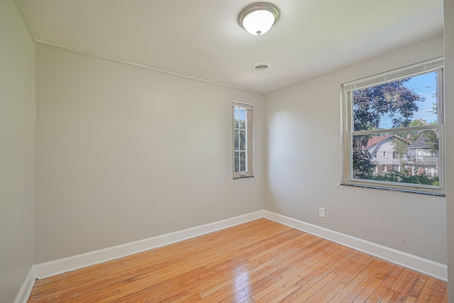 spare room with light hardwood / wood-style flooring and ornamental molding