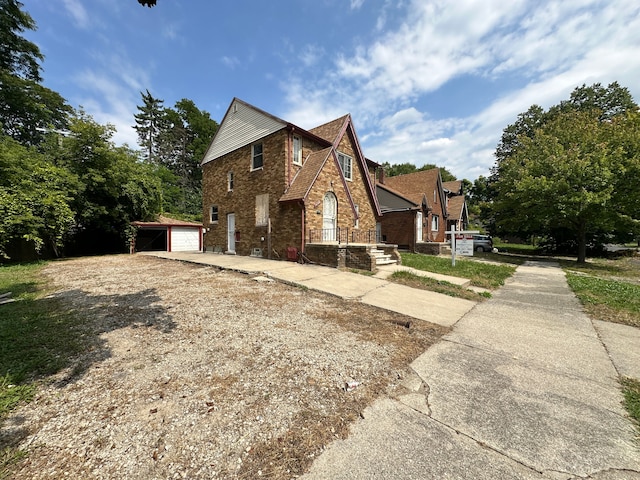 view of home's exterior featuring a garage and an outbuilding