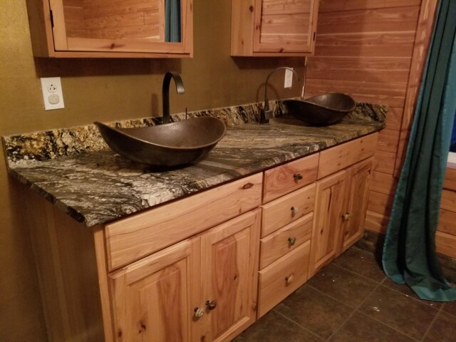 9034 W Bass Lake Rd, Irons, MI 49644 - bathroom with tile patterned floors and double vanity