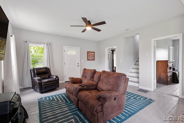 living room featuring ceiling fan and light wood-type flooring