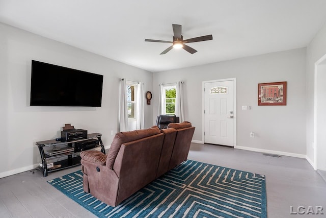 living room featuring ceiling fan and hardwood / wood-style flooring