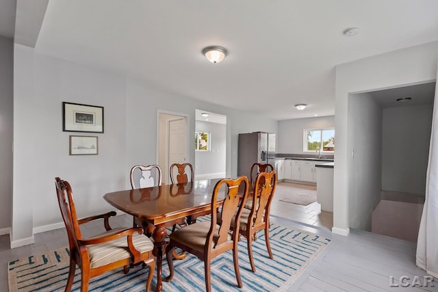 dining area featuring sink and light hardwood / wood-style floors