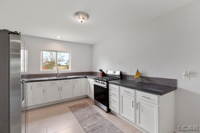 kitchen with white cabinetry, sink, and appliances with stainless steel finishes