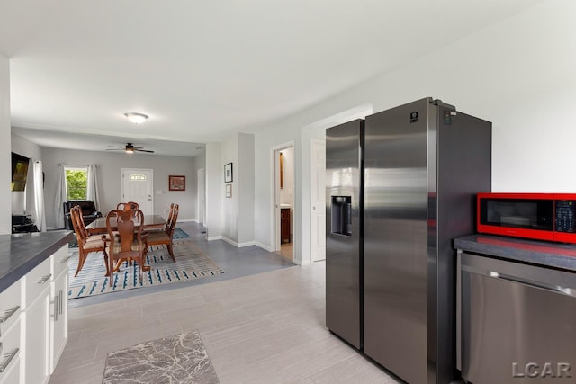 kitchen with ceiling fan, white cabinets, and appliances with stainless steel finishes