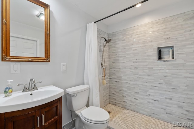 bathroom with a shower with curtain, vanity, and toilet