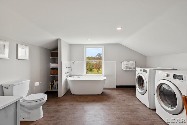 washroom featuring dark hardwood / wood-style flooring and washer and dryer