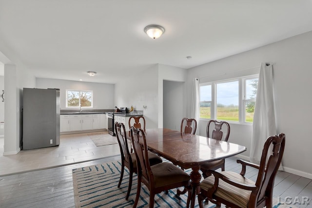 dining room featuring sink and light hardwood / wood-style floors