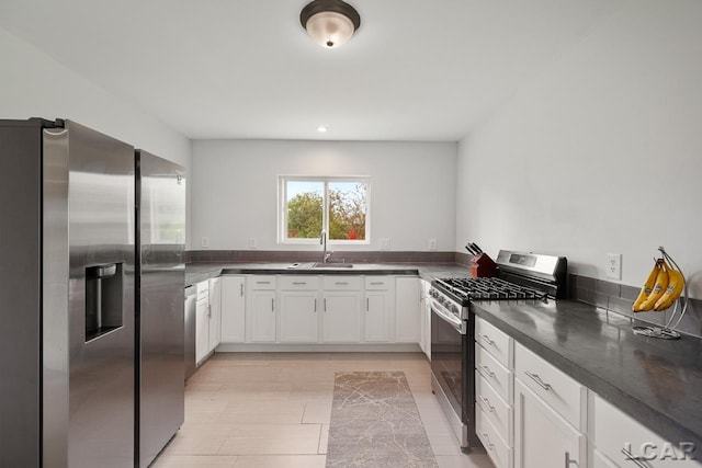 kitchen featuring sink, white cabinets, and appliances with stainless steel finishes