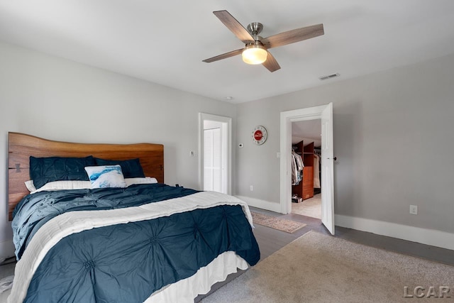 carpeted bedroom featuring ceiling fan and a closet