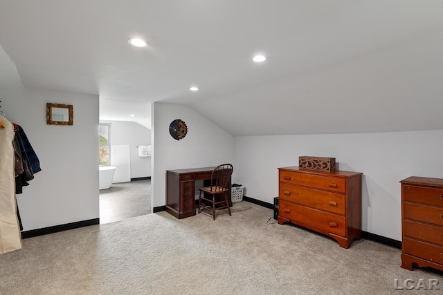 office area featuring light carpet and lofted ceiling