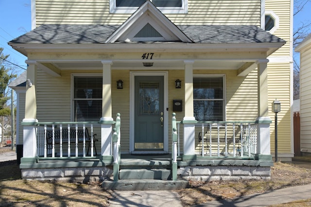 417 Barlow St, Traverse City, MI 49686 - view of front facade with a porch and roof with shingles