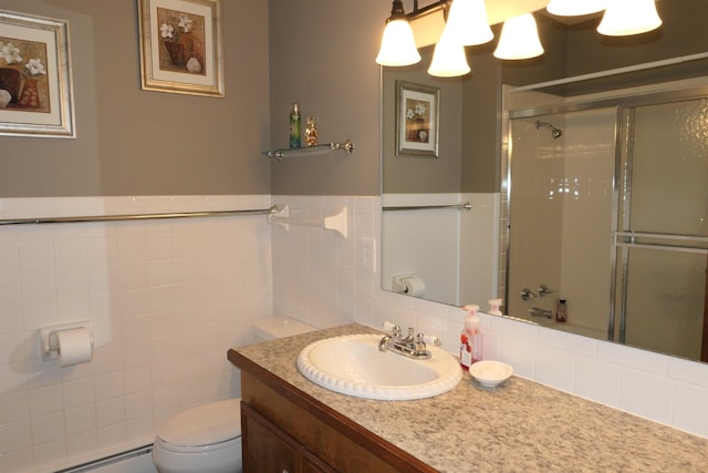 bathroom with vanity, toilet, tile walls, baseboard heating, and walk in shower