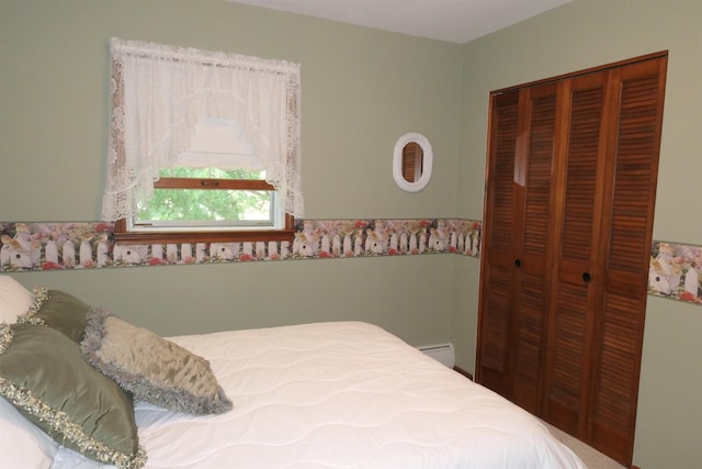 bedroom with a closet and a baseboard radiator